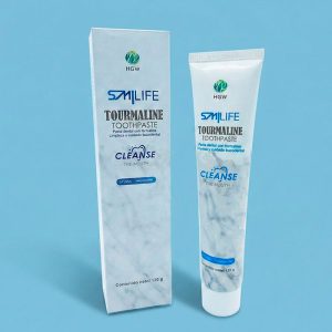 Tubo y caja de la crema dental blanca Smilife Tourmaline de HGW exhibidos